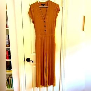 Mustard yellow, jump suit, with pockets.